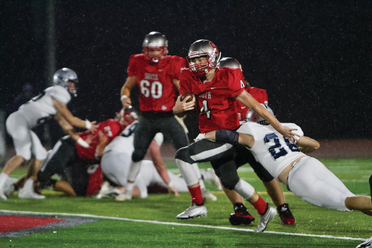 Southmont quarterback Nick Scott fights for extra yards in the Mounties 27-0 sectional loss vs Lafayette Central Catholic